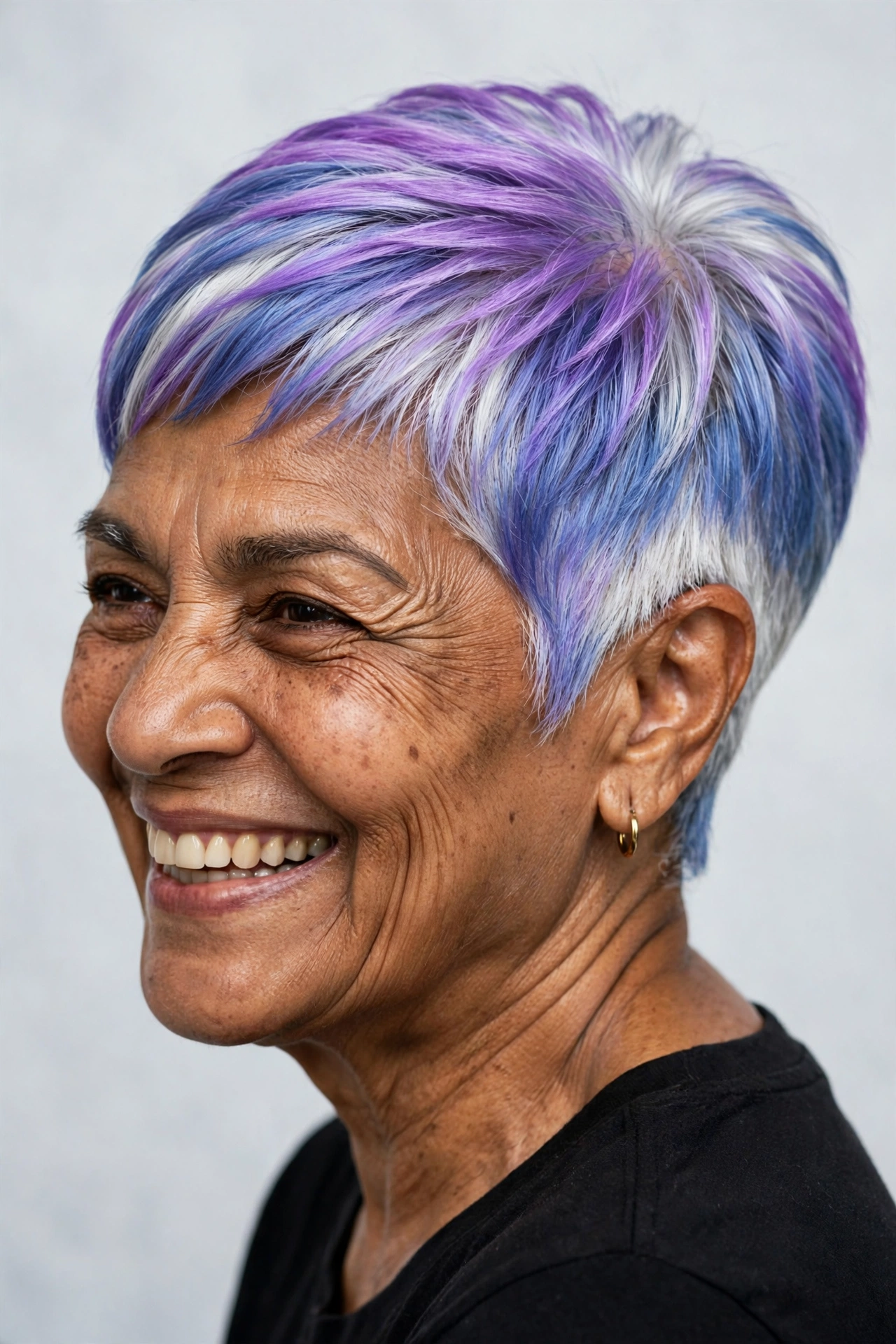 Bold vivid lavender-purple pixie on a woman over 60 with soft taper