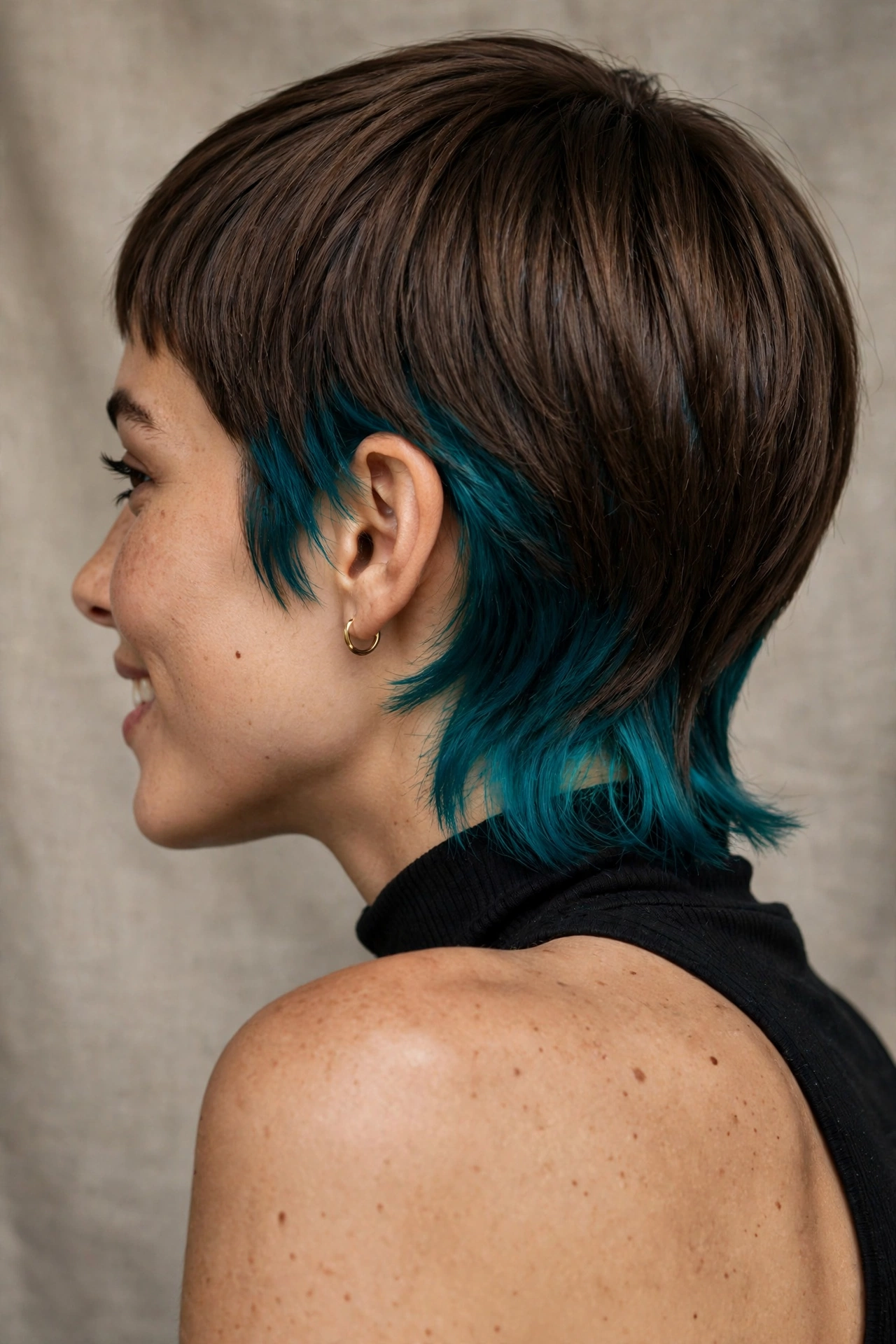 Pixie cut with peek-a-boo teal colour underneath at nape